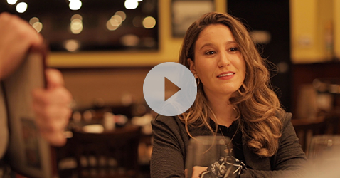 link to video of woman smiling at dinner table